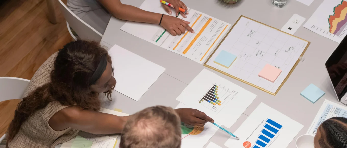 Small business owner and team planning digital marketing channels together